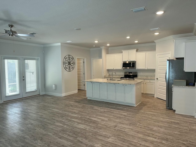 kitchen featuring french doors, stainless steel appliances, sink, light hardwood / wood-style flooring, and white cabinets