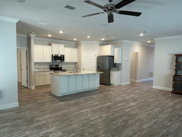 kitchen with white cabinets, hardwood / wood-style floors, stainless steel appliances, and a center island with sink