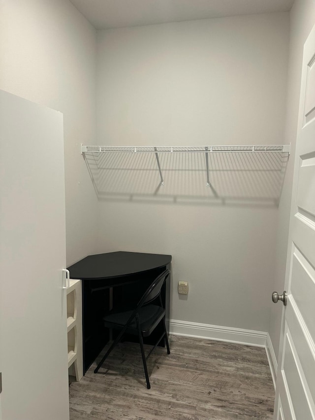 clothes washing area with dark wood-type flooring