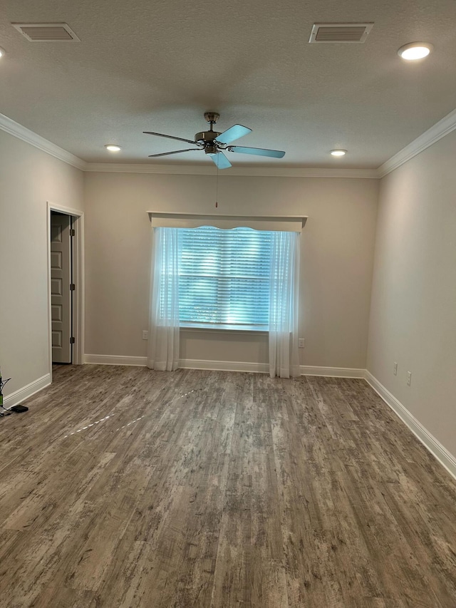 empty room featuring hardwood / wood-style flooring, ceiling fan, ornamental molding, and a textured ceiling