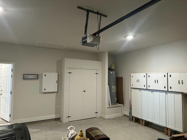 garage featuring electric panel, a garage door opener, and water heater