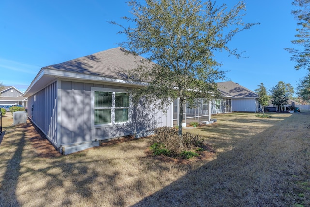 exterior space with cooling unit and a front yard