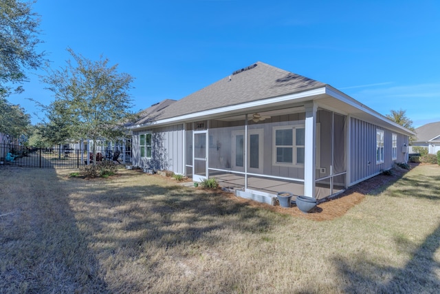 back of house featuring a yard and a sunroom