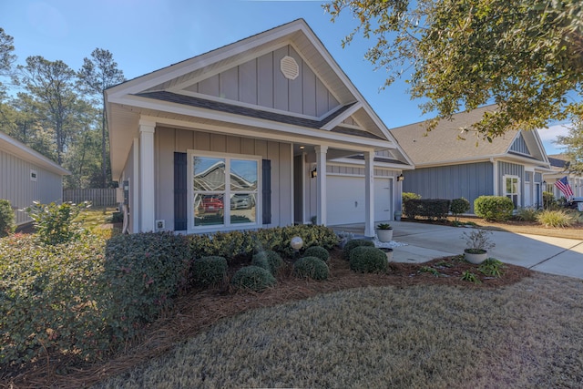 view of front facade featuring a porch, a garage, and a front lawn