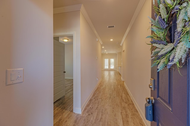 hallway with crown molding and light hardwood / wood-style floors