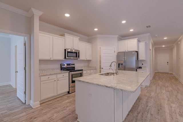 kitchen featuring appliances with stainless steel finishes, sink, white cabinets, and light stone counters