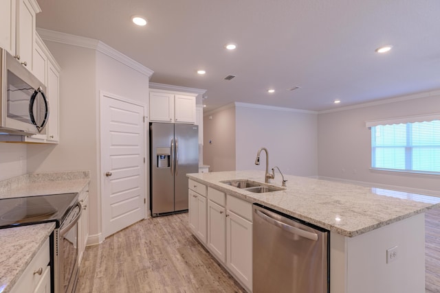 kitchen featuring white cabinetry, a center island with sink, ornamental molding, and appliances with stainless steel finishes