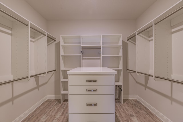 walk in closet with light wood-type flooring