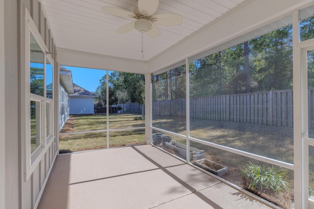 unfurnished sunroom featuring ceiling fan