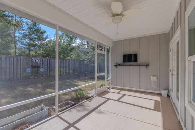 unfurnished sunroom featuring plenty of natural light and ceiling fan