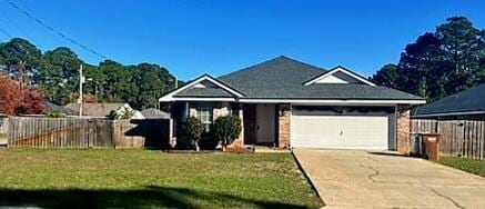 view of front of house featuring a garage and a front lawn