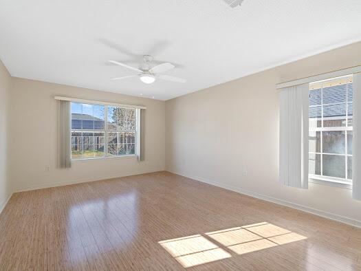 unfurnished room with ceiling fan and light hardwood / wood-style flooring