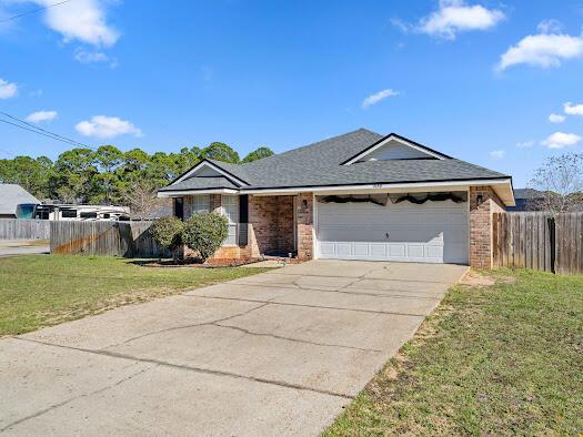 ranch-style house with a garage and a front yard