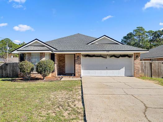 ranch-style house with a garage and a front lawn