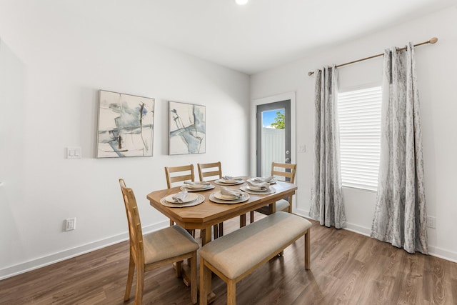 dining space with dark hardwood / wood-style flooring