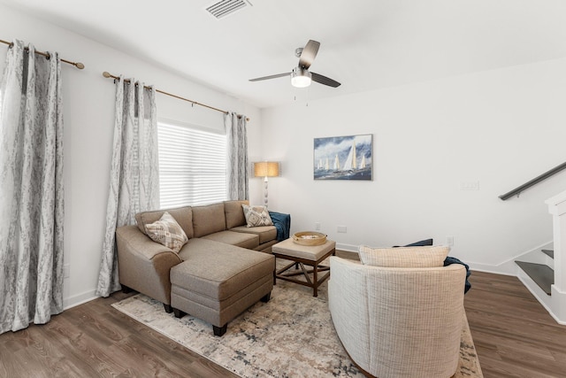 living room featuring wood-type flooring and ceiling fan