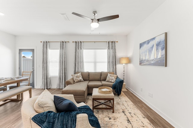 living room featuring ceiling fan and light hardwood / wood-style flooring