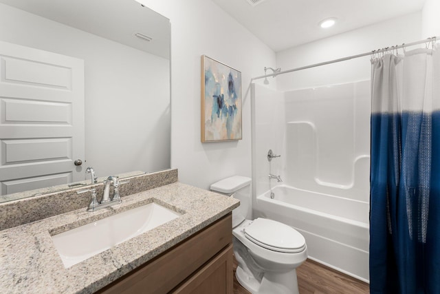 full bathroom featuring hardwood / wood-style floors, vanity, toilet, and shower / bath combo