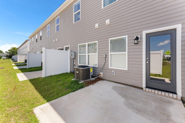 back of house featuring a patio area, a yard, and central AC