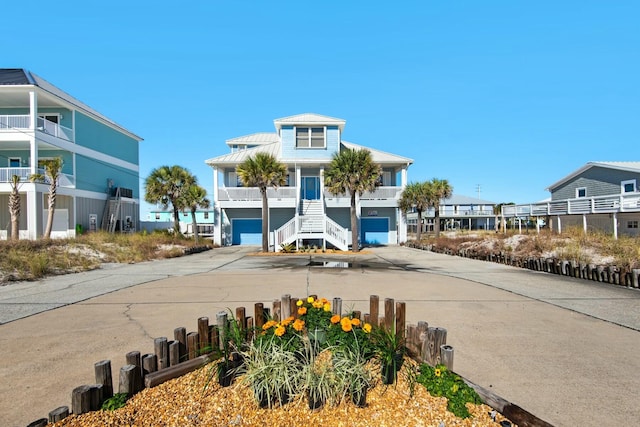 7646 Gulf Blvd, Navarre, FL 32566 - view of building exterior with driveway, stairway, and an attached garage