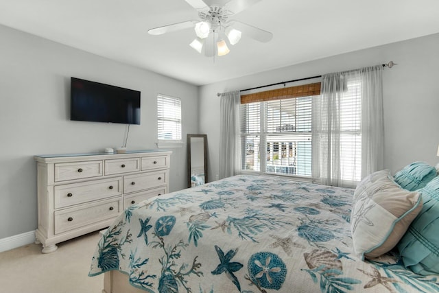 bedroom with light colored carpet and ceiling fan