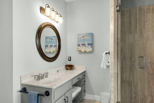 bathroom featuring vanity and a shower with shower door