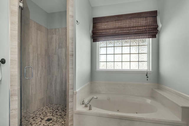 bathroom featuring separate shower and tub