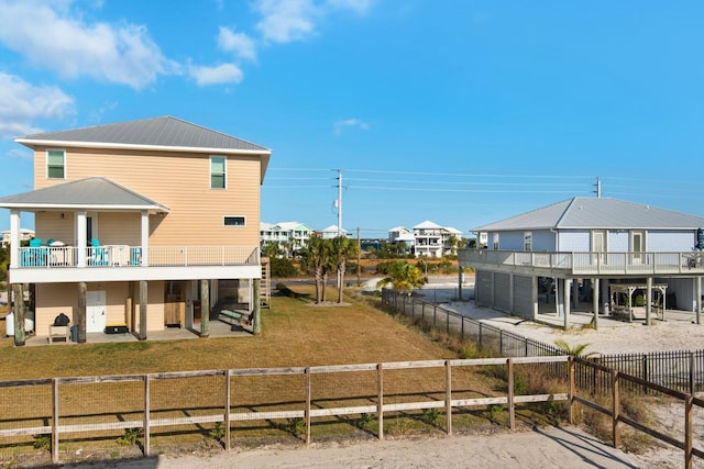7646 Gulf Blvd, Navarre, FL 32566 - rear view of property featuring a fenced backyard, a patio area, a metal roof, and a deck
