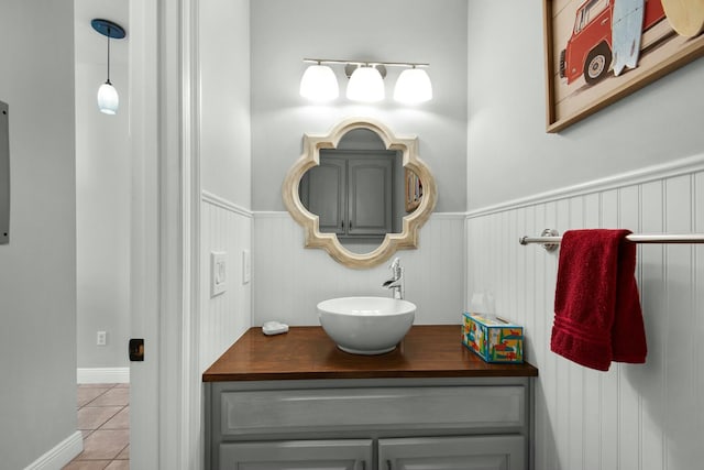 7646 Gulf Blvd, Navarre, FL 32566 - bathroom with vanity, tile patterned floors, and wainscoting