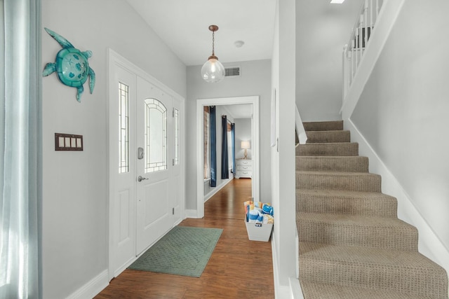 7646 Gulf Blvd, Navarre, FL 32566 - entrance foyer featuring dark wood-style floors and stairs