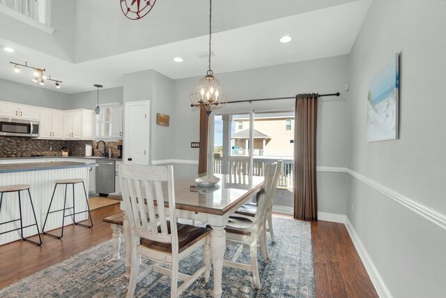 7646 Gulf Blvd, Navarre, FL 32566 - dining room with wood finished floors, a chandelier, and recessed lighting