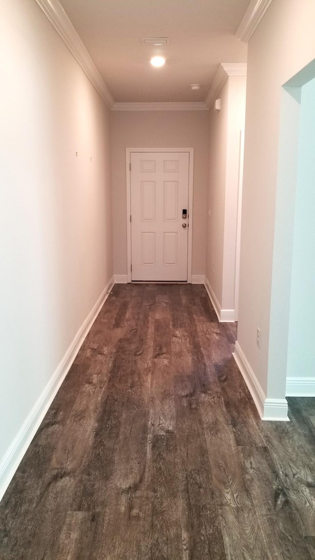 hall with dark hardwood / wood-style floors and ornamental molding