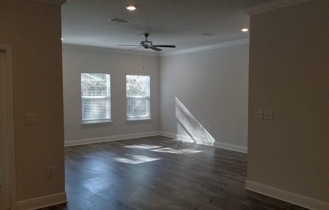 empty room featuring crown molding, ceiling fan, and dark hardwood / wood-style floors