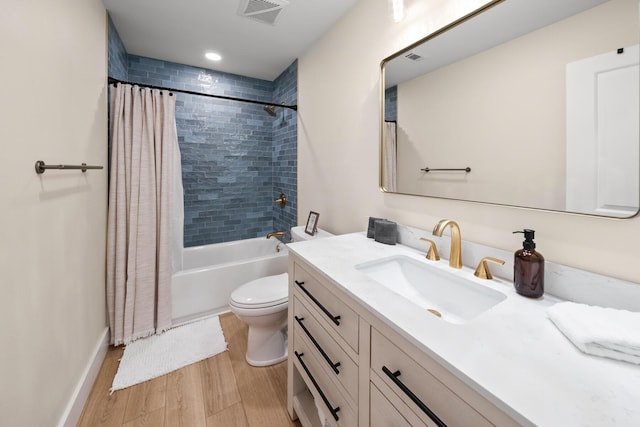 full bathroom featuring shower / tub combo, vanity, hardwood / wood-style flooring, and toilet