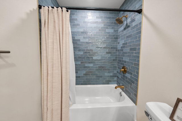 bathroom featuring shower / bath combination with curtain and toilet