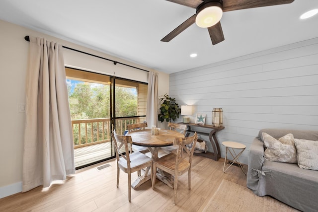 dining space featuring light wood-type flooring and ceiling fan