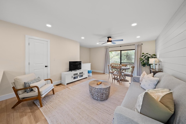 living room featuring ceiling fan and light hardwood / wood-style flooring