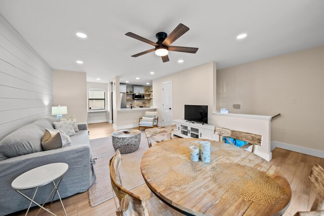 dining space with ceiling fan and light hardwood / wood-style floors