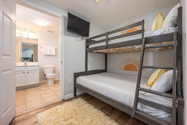 tiled bedroom featuring connected bathroom