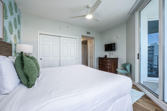 bedroom featuring access to outside, a closet, hardwood / wood-style flooring, and ceiling fan