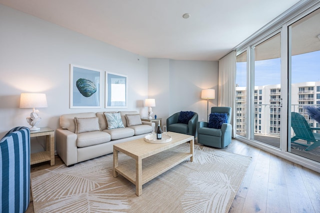 living room featuring light hardwood / wood-style flooring and floor to ceiling windows