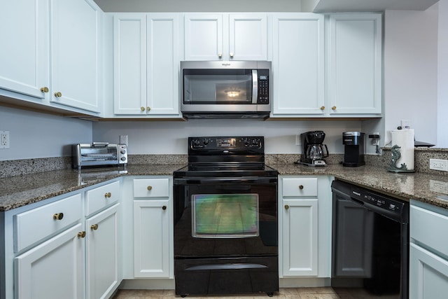 kitchen with dark stone counters, white cabinetry, and black appliances