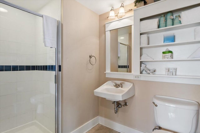 bathroom featuring walk in shower, toilet, and sink