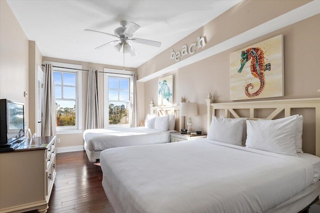 bedroom with ceiling fan and dark hardwood / wood-style flooring