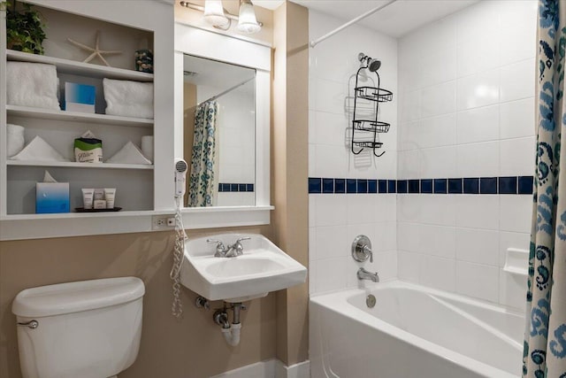 full bathroom featuring sink, shower / tub combo, and toilet