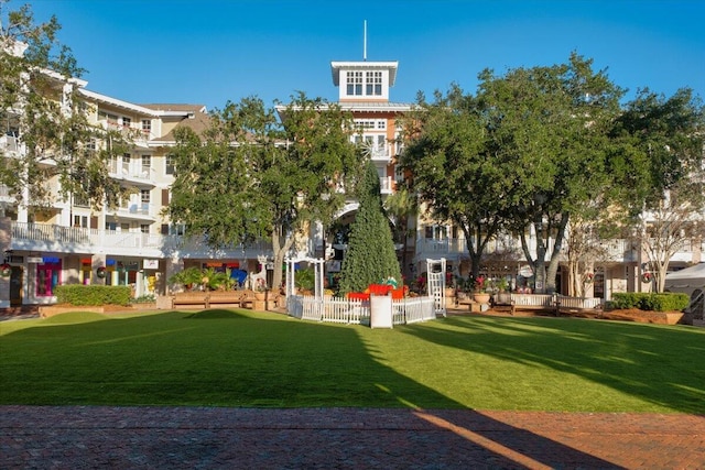 view of home's community featuring a lawn