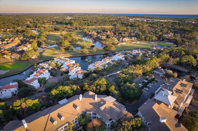 aerial view at dusk featuring a water view