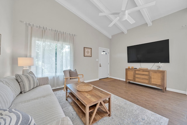 living room with beam ceiling, ceiling fan, hardwood / wood-style floors, and high vaulted ceiling