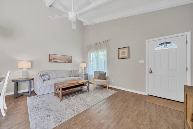 living room featuring beam ceiling, ceiling fan, and hardwood / wood-style floors