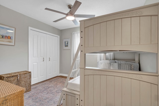 bedroom with hardwood / wood-style floors, a closet, and ceiling fan